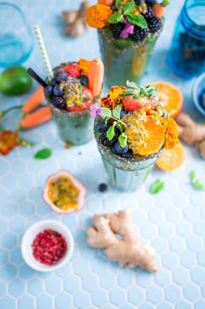 Smoothies on a blue tile surface.